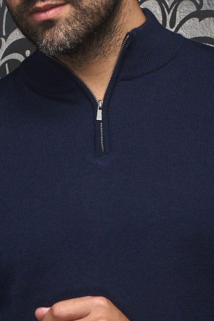 Close-up of a navy blue merino wool sweater with a high collar and zipper.