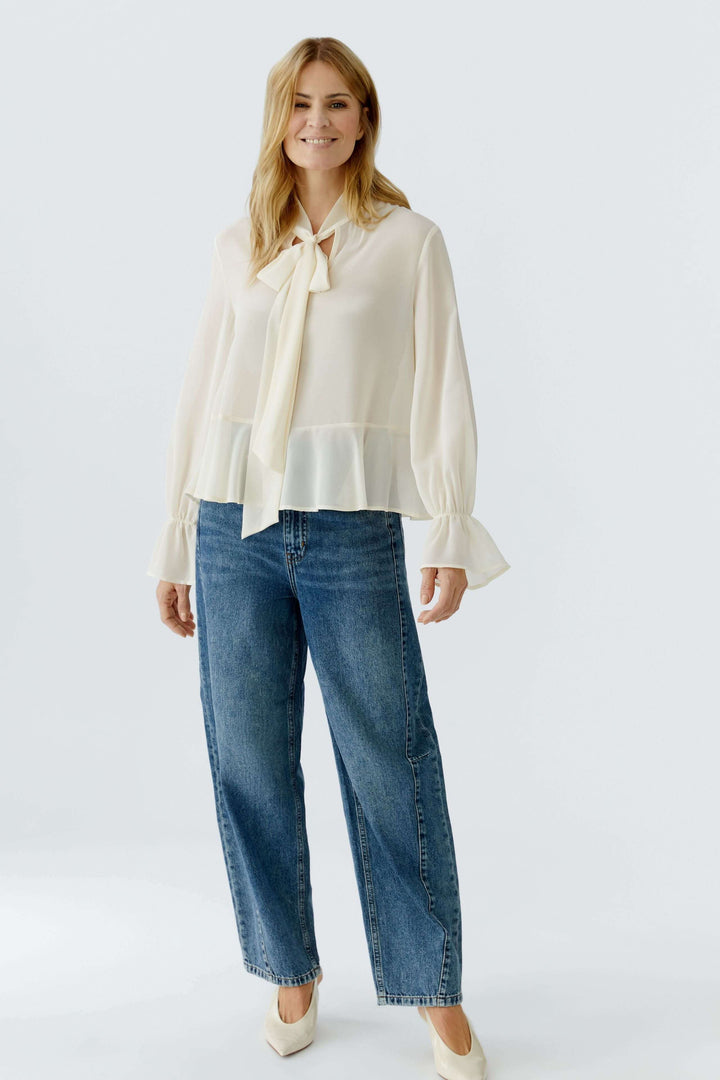 Blouse fluide à cravate col noué en tissu léger, parfait pour un look chic et intemporel.