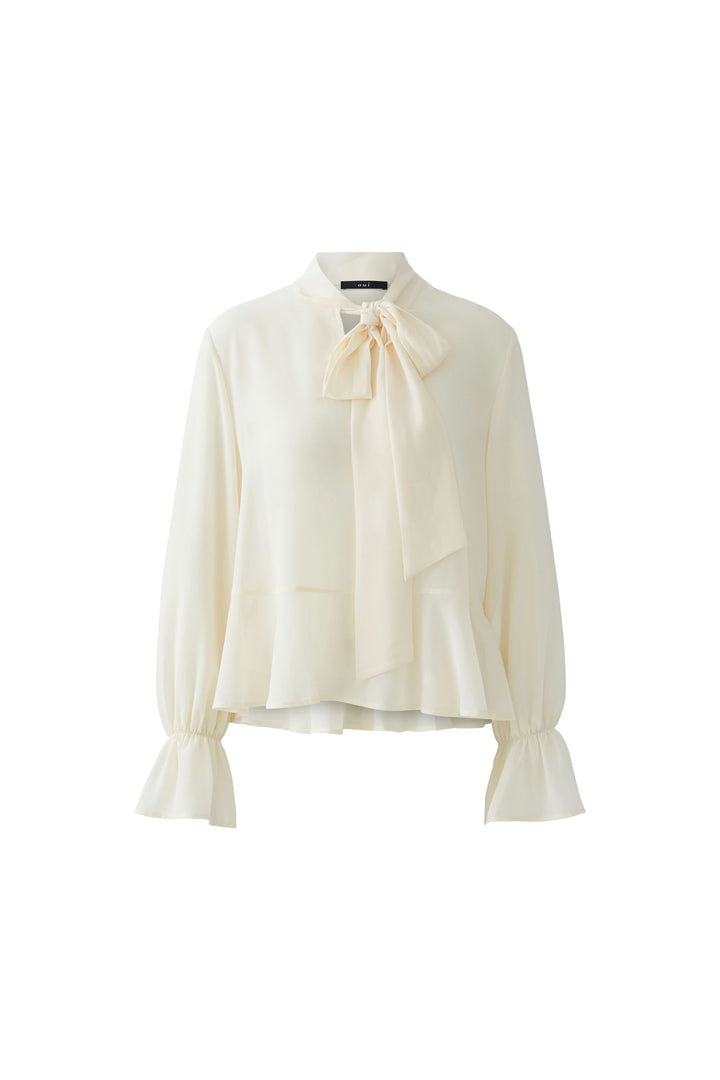 Blouse fluide à cravate col noué élégante avec manches longues et poignets volantés pour une touche chic et intemporelle.