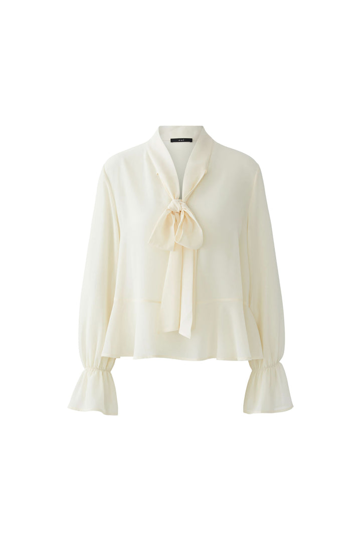 Blouse fluide à cravate col noué avec manches longues et poignets volantés, élégante pièce chic pour bureau ou tenue habillée.