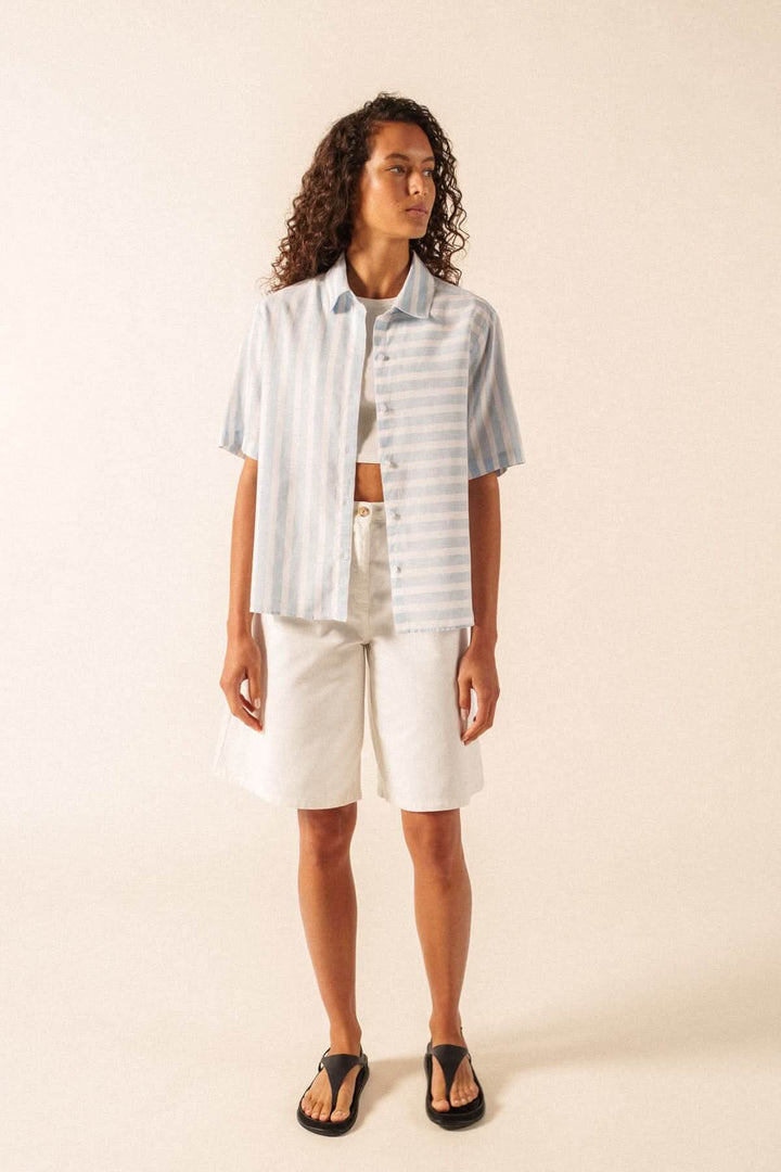 Blouse à rayures manches courtes ALMA portée par un mannequin avec short blanc, style décontracté et estival.