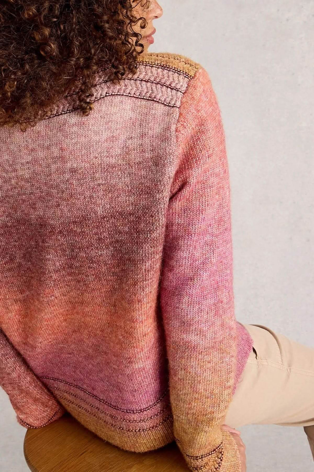 Chandail Lilbet en maille dégradée nuances chaudes avec poche kangourou, style décontracté et moderne, portée avec pantalon clair.