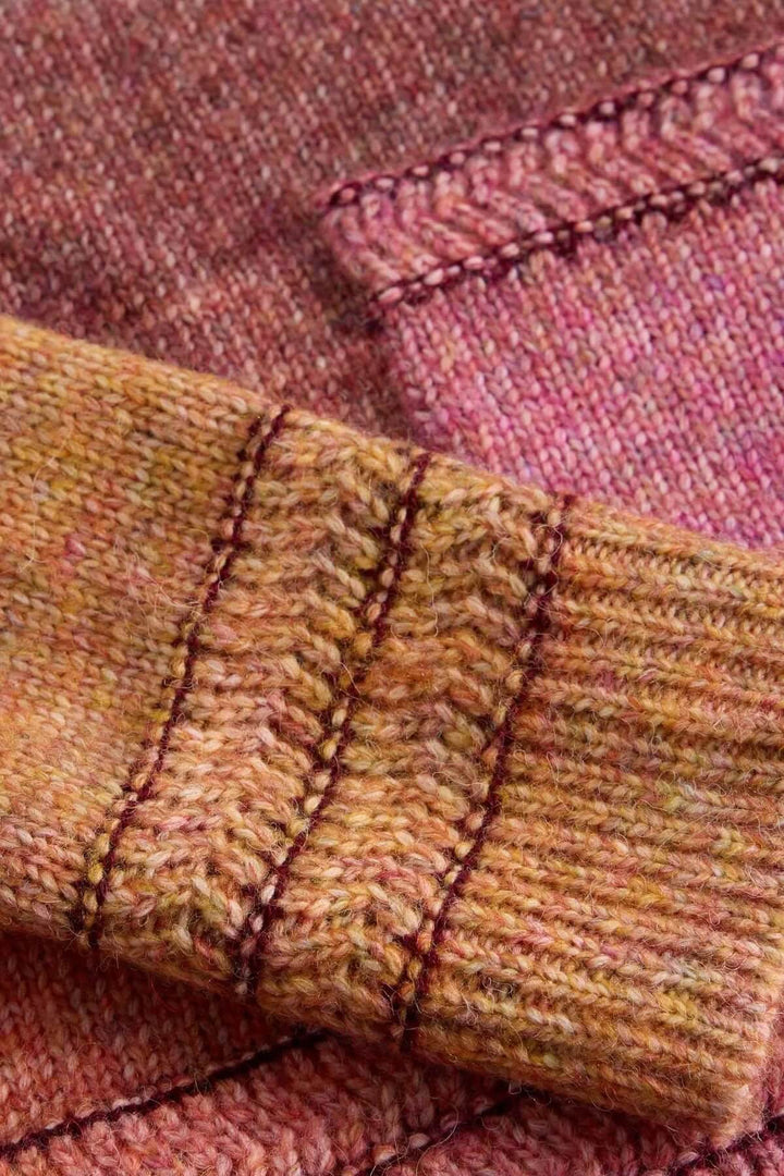 Chandail Lilbet en maille dégradée avec nuances chaudes et détails sur les manches, idéal pour un style moderne et confortable.