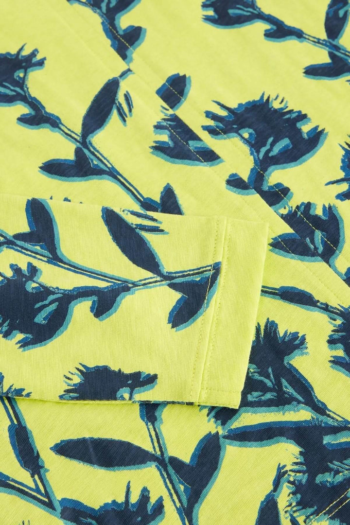 Imprimé floral subtil sur tissu jaune vif, détails en bleu sur le chandail à col cranté Nelly.