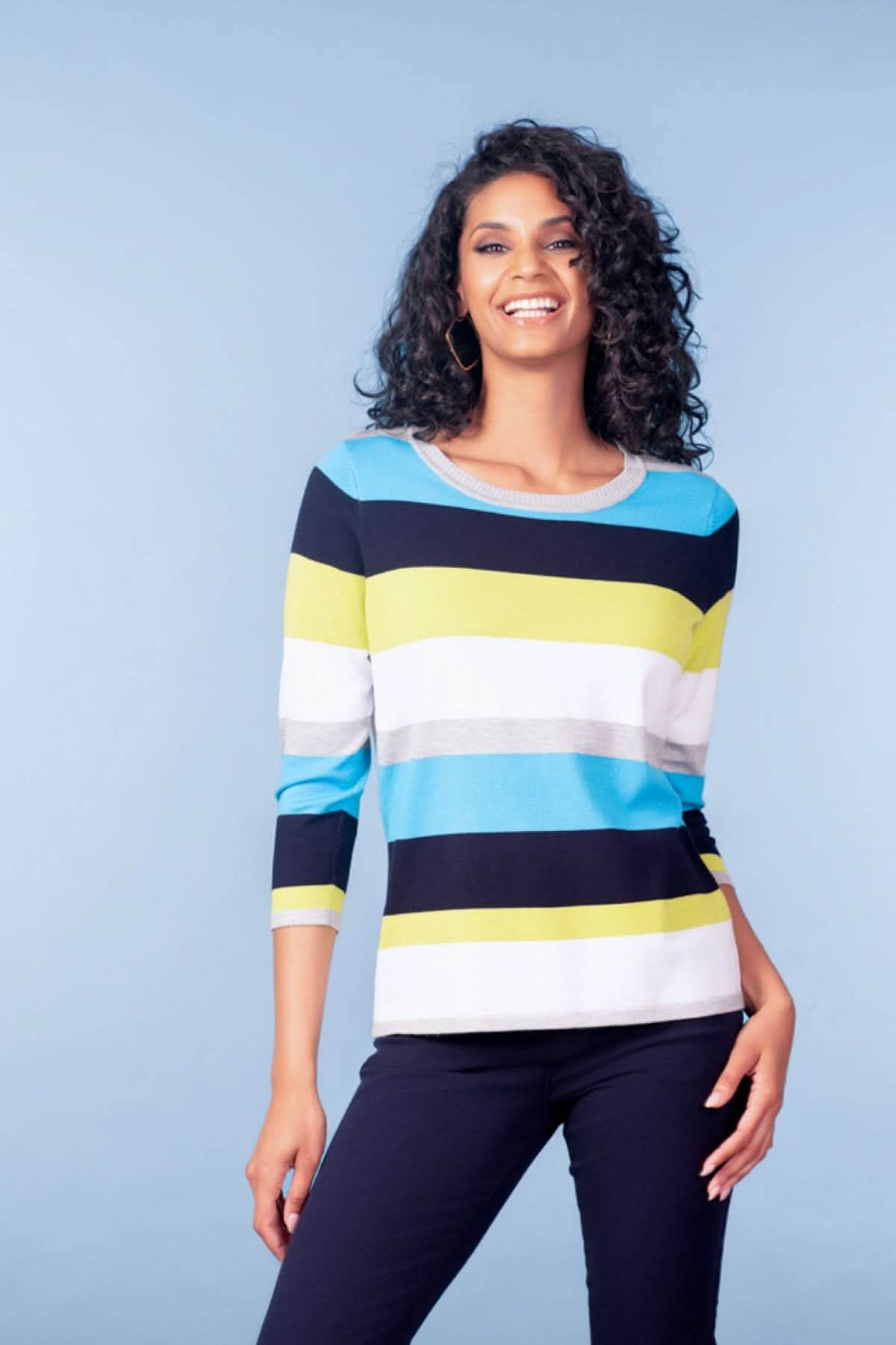 Femme portant un chandail à rayures manches trois-quarts, coupe droite et moderne, idéal pour un look au quotidien ou au bureau.