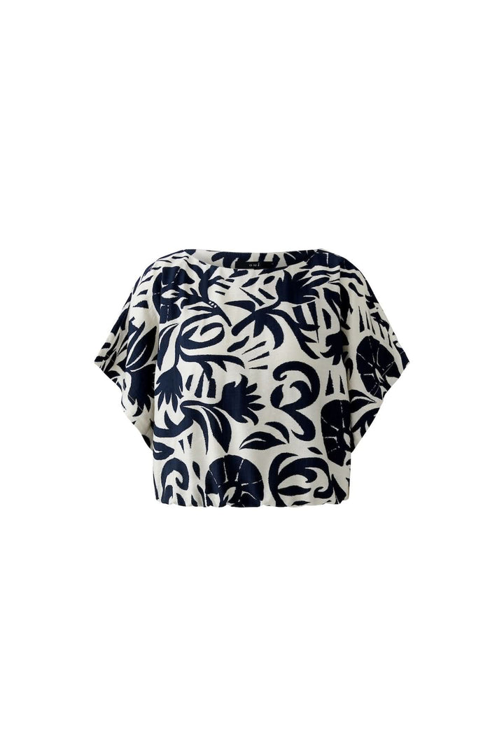 Chemisier à manches courtes imprimé artistique avec design audacieux et coupe fluide, idéal pour un look moderne et décontracté.