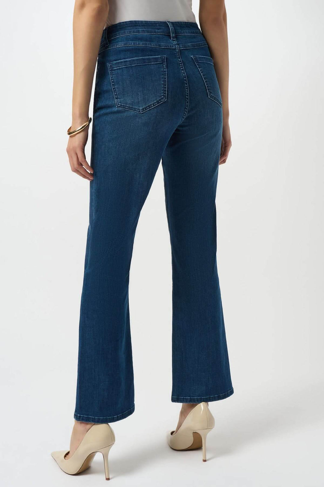 Jeans bleu classique coupe droite légèrement évasée, taille mi-haute, fermés par bouton métallique, poches arrière visibles.