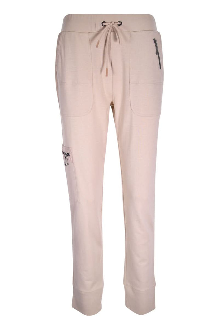Jogging ajusté, pantalon utilitaire beige avec coupe ajustée, taille élastique et poches zippées, confort et style pour le quotidien.