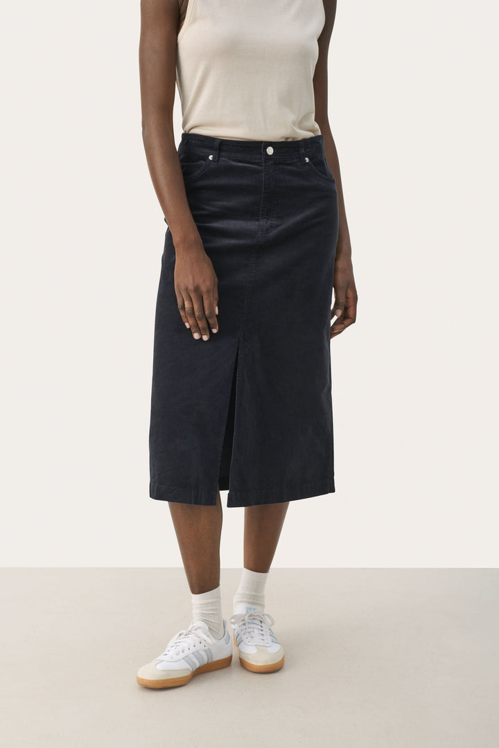 Jupe longue en velours côtelé avec fente, worn casually with a tank top and sneakers, styled for everyday wear.