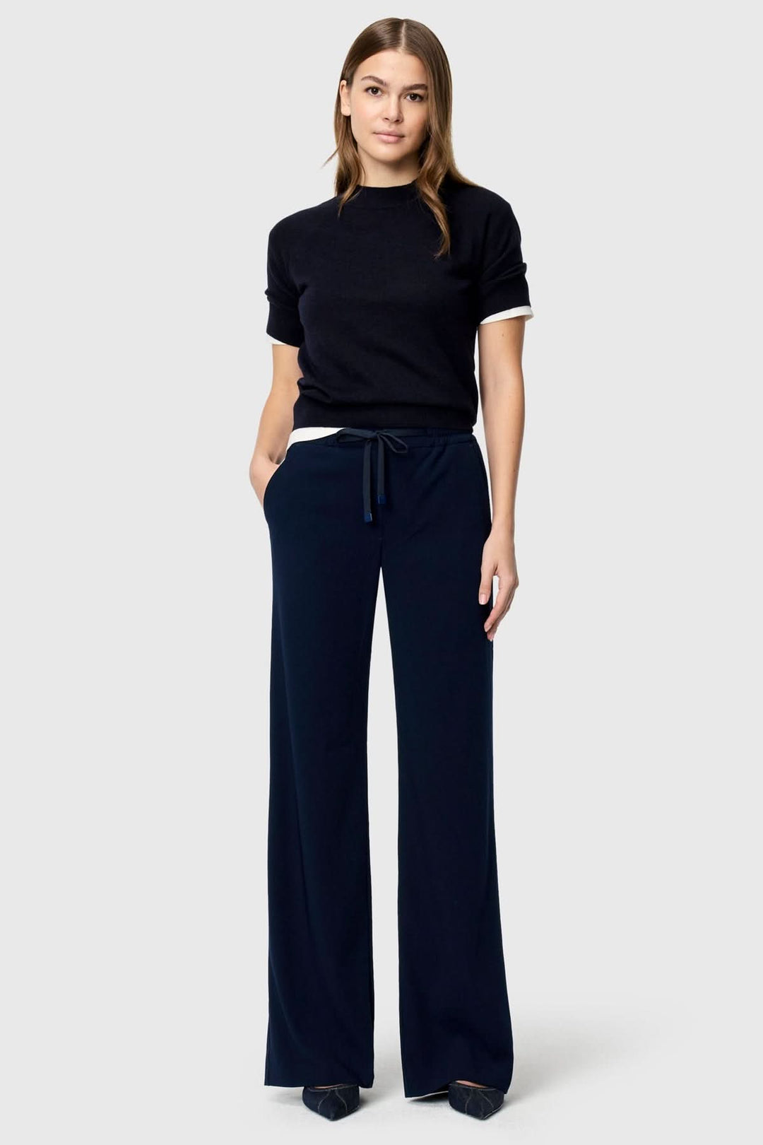 Femme portant Pantalon fluide CHRISTY avec coupe droite et taille élastique ajustable, tenue élégante et confortable.