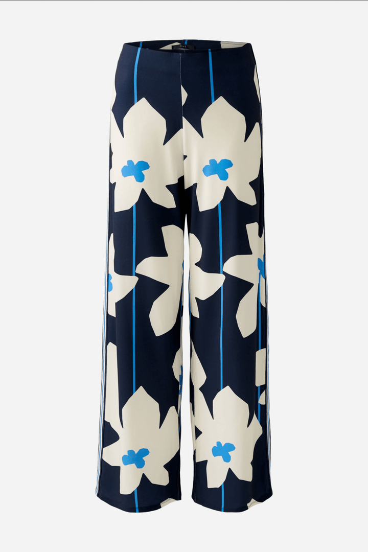 Pantalon ample à imprimé floral bleu et blanc, confortable avec taille élastiquée, idéal pour un look chic.