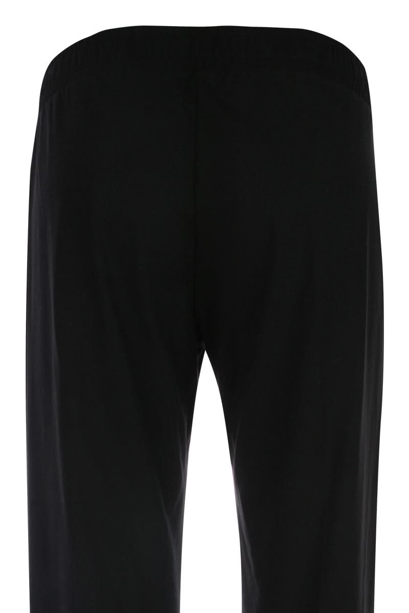 Vue arrière d'un pantalon jambe large en tissu fluide noir.