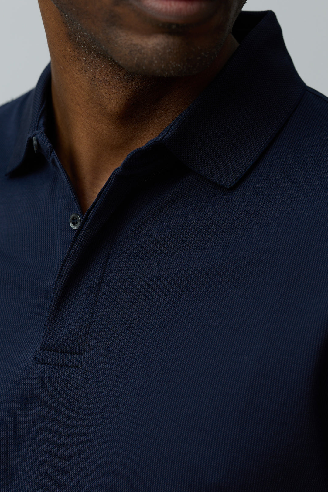 Polo en coton Corneliani bleu marine ajusté avec col classique et maille texturée, idéal pour un look casual-chic élégant.