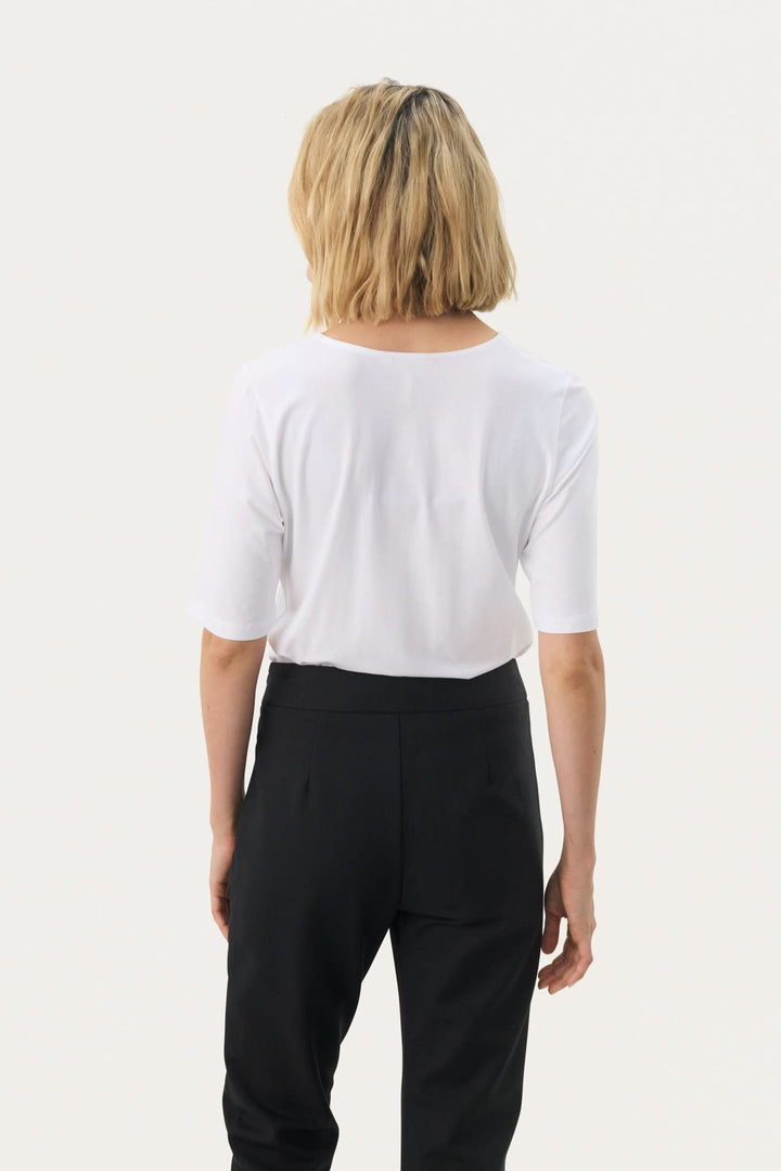 Femme portant un T-shirt coupe droite Nemi blanc, vue de dos, style épuré et confortable, tendance moderne.