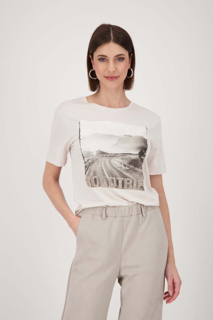 Femme portant un T-shirt imprimé avec motif photo "road trip" pour un style casual chic.