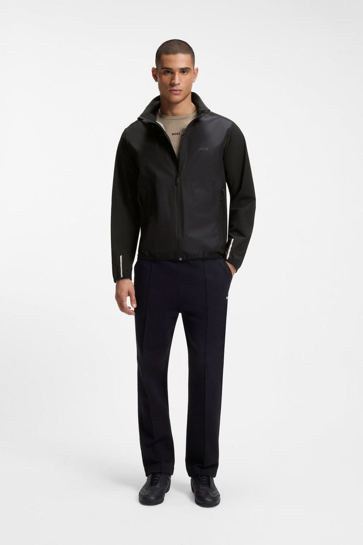 Homme portant une veste légère zippée à col montant, silhouette moderne, coupe droite pour une tenue décontractée ou sportive élégante.