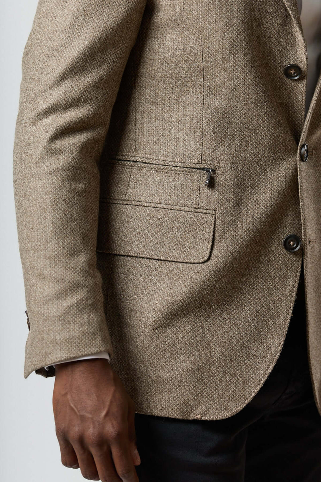 Veston texturé en laine avec col amovible intégré, boutonnière et insert zippé, sur un mannequin portant du noir et une chemise blanche.