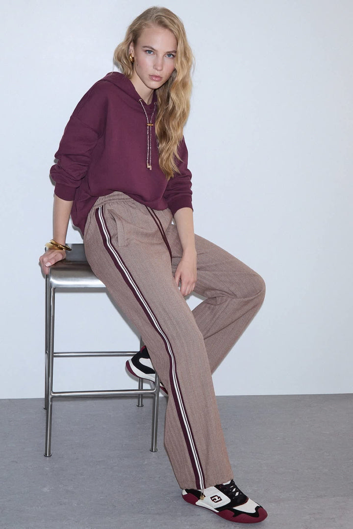 Black jogging pants with fine stripes and side bands, front view for women liujo