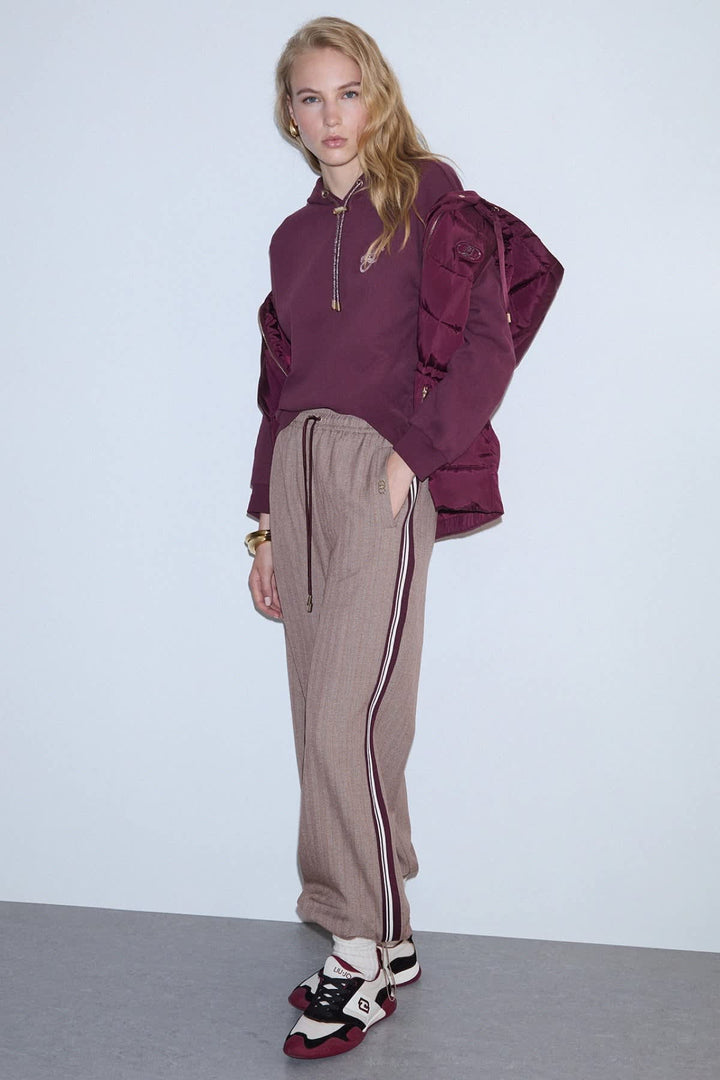 Black jogging pants with fine stripes and side bands, front view for women liujo