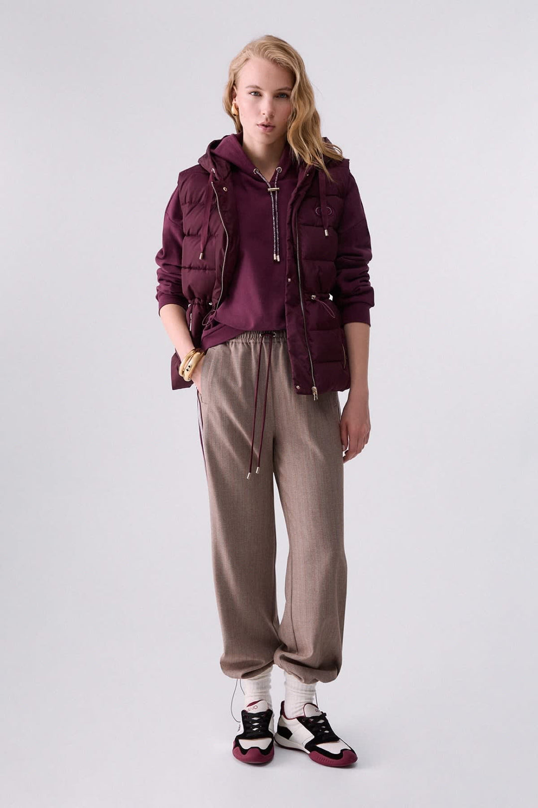 Joggers with fine stripes and side bands, front view for women liujo