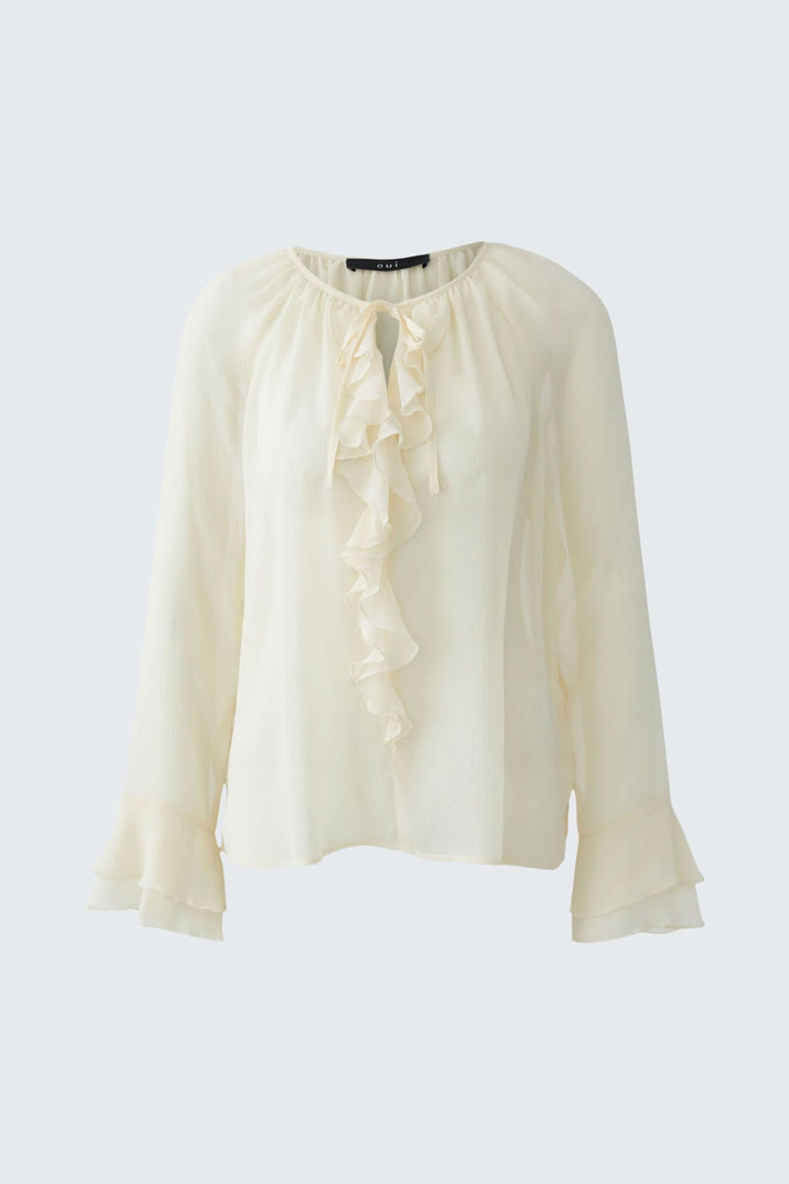 Blouse fluide à volants et lien au col en tissu léger, idéale pour un look chic et romantique, décris moi le produit en français.