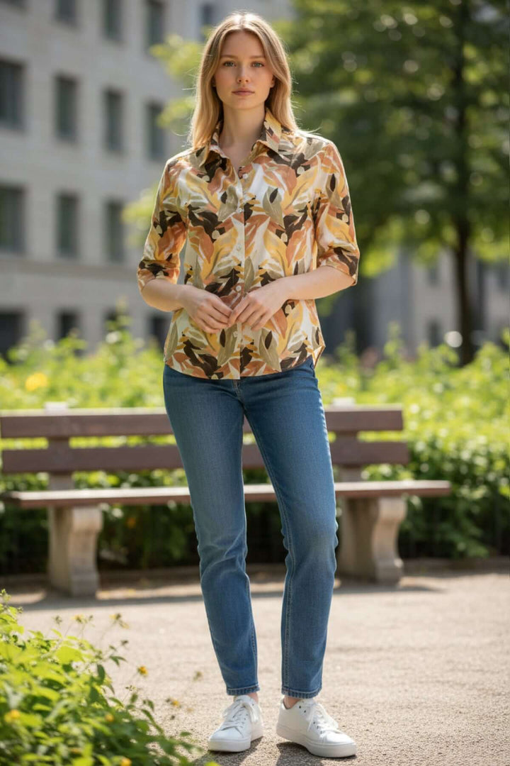 Femme portant la chemise imprimée ALICE avec un motif estival et décontracté, coupe droite, col classique et fermeture boutonnée.
