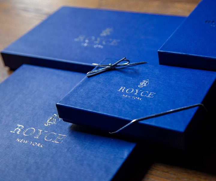 Luxurious blue gift boxes with ROYCE New York logo, perfect for personalized leather items.